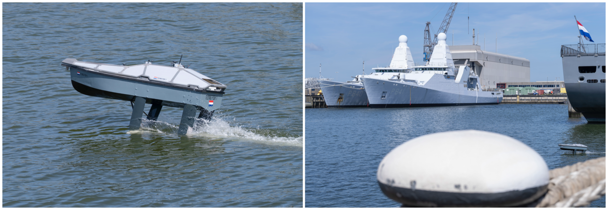 Een drone scheert over het water. Aan de ene kant is deze in het geheel te zien, daarnaast als klein stipje tussen de grote marineschepen die aan wal liggen.