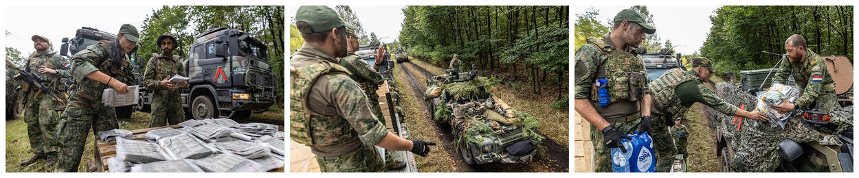 Voertuigen van 110 Transportcompagnie vormen de Bevostraat.