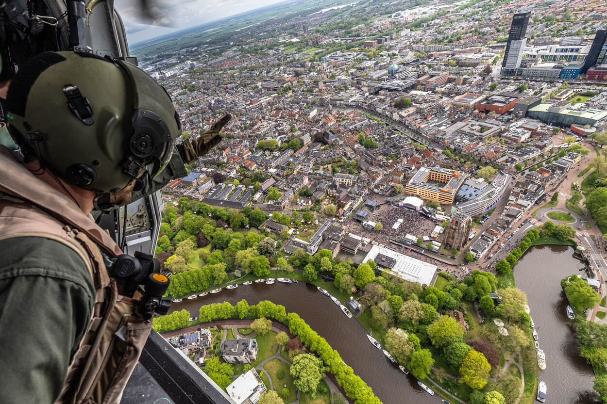 Aangekomen boven Leeuwarden zwaait de NH90-bemanning alvast naar het publiek dat is verzameld op het Oldehoofsterkerkhof.