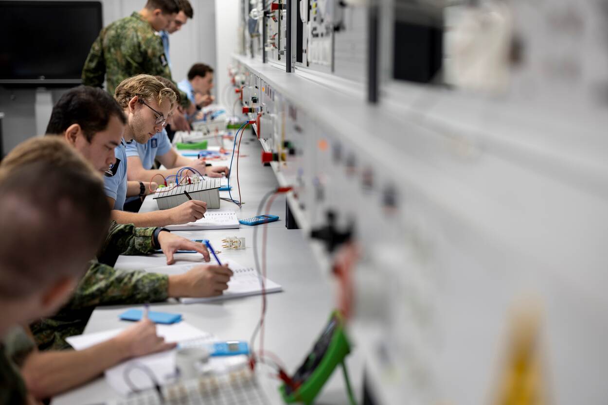 Marechaussees zittend bezig in het practicumlokaal.