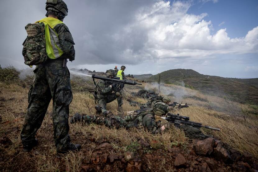 Op de foto verschillende mariniers in actie, onder wie een schutter met een geschouderde Panzerfaust.