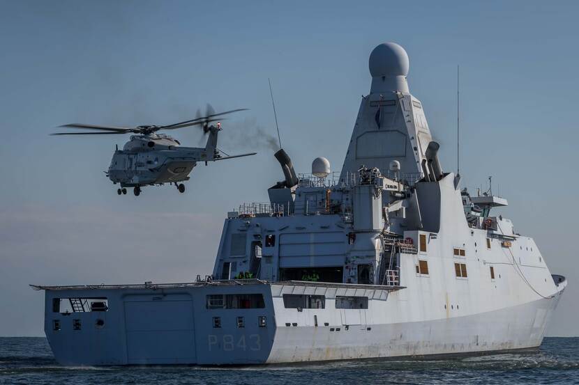 Zr.Ms. Groningen met een helikopter boven het helidek.