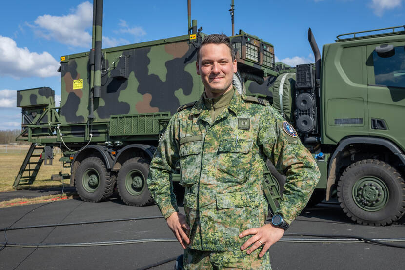 Portretfoto van sergeant Thjeu. Op de achtergrond staat een legertruck.