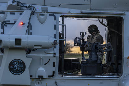 Mariniers rennen de NH90 uit en er hangt vracht onder de heli.